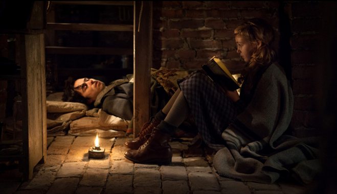 This image released by 20th Century Fox shows Ben Schnetzer, left, and Sophie Nélisse in a scene from "The Book Thief," about a girl who loves books. (AP Photo/20th Century Fox, Jules Heath)