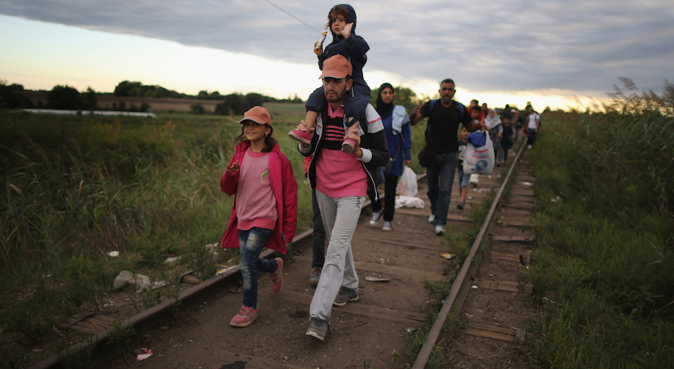 SZEGED, HUNGARY - SEPTEMBER 06: Migrants and refugees cross the border from Serbia into Hungary along the railway tracks close to the village of Roszke on September 6, 2015 in Szeged, Hungary.After days of confrontation and choas Hungary unexpectedly opened its borders with Austria allowing thousands of migrants to leave the country and travel onto Germany. (Photo by Christopher Furlong/Getty Images)