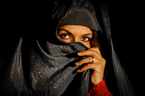An Afghan woman looks into the camera in Mazar-i Sharif, capital of Balkh province, on March 30, 2012. Mazar-i Sharif is the capital of Balkh province with an existence of multi-ethnic groups such as Uzbeks, Turkmen, Tajiks and Hazaras. Mazar-i Sharif means ëRespected Shrineí but the city is known by tourists as the city of the blue mosque which is located in the center of the city known as the Shrine of Hazrat Ali. AFP PHOTO/ Qais Usyan