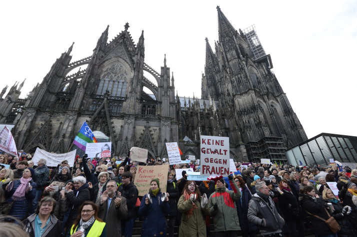 People take part in a demonstration against violence against women in front of the cathedral in Cologne, western Germany, on January 9, 2015 where sexual assaults in a crowd of migrants took place on New Year's Eve. / AFP / Roberto Pfeil (Photo credit should read ROBERTO PFEIL/AFP/Getty Images)