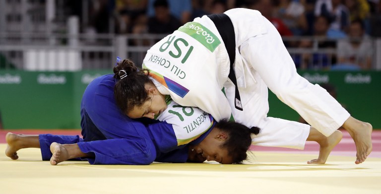 Israel's Gili Cohen (white) competes with Mauritius' Christianne Legentil during their women's -52kg judo contest match of the Rio 2016 Olympic Games in Rio de Janeiro on August 7, 2016. / AFP PHOTO / Jack GUEZ