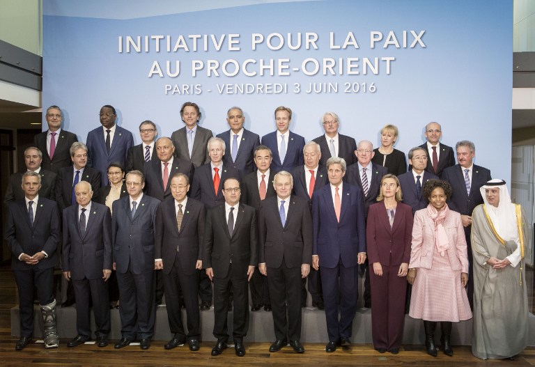 French President Francois Hollande (C), United Nations Secretary General Ban Ki-moon (C-L), French Foreign minister Jean-Marc Ayrault (C-R), US Secretary of State John Kerry (4th R), European Union High Representative for Foreign Affairs, Federica Mogherini (3rd R) and officials pose for a group photo prior to an international meeting in a bid to revive the Israeli-Palestinian peace process in Paris, on June 3, 2016. France will host talks on the Israeli-Palestinian conflict that have received a chilly response from Washington, but diplomats say merely swinging the spotlight back onto the stalemate is a victory. Instead representatives of some 25 countries, as well as the United Nations, European Union and Arab League, will try and lay the ground for a fully-fledged peace conference to be held by the end of the year. / AFP PHOTO / POOL / Kamil Zihnioglu