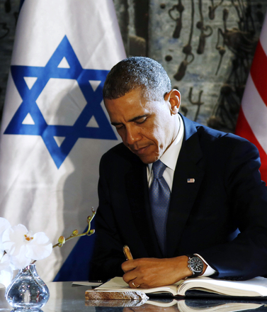 U.S. President Barack Obama signs the guest book at the residence of Israel's President Shimon Peres in Israel