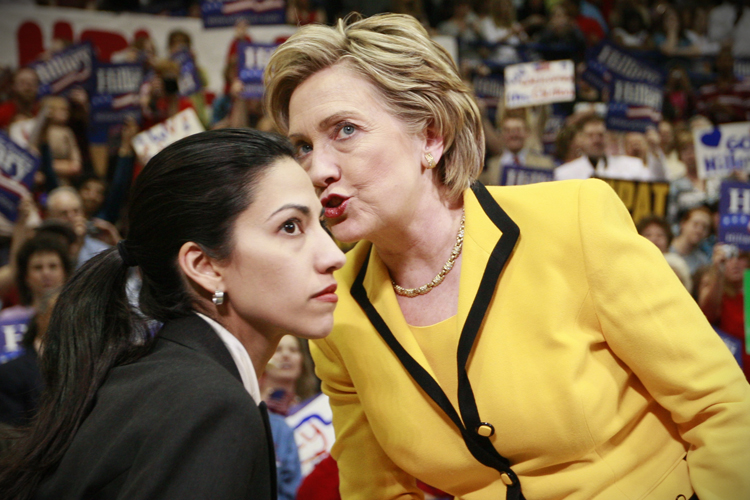 Democratic presidential hopeful, Sen. Hillary Rodham Clinton, D-N.Y., has a word with aide Huma Abedin at the start of a campaign rally at Capital High School in Charleston, W.Va., Wednesday, March 19, 2008. (AP Photo/Charles Dharapak)